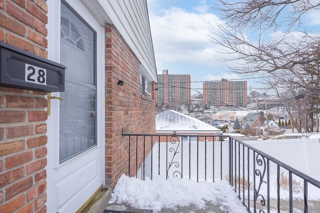 view of snow covered back of property