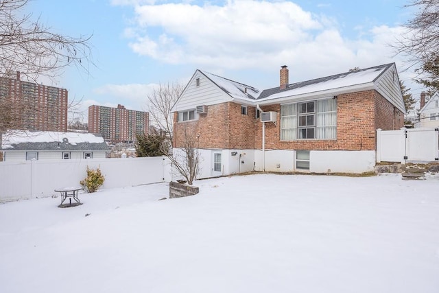 view of snow covered back of property