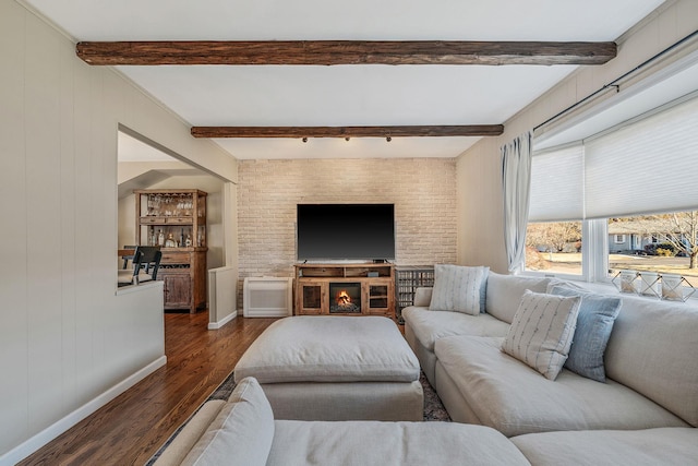 living room featuring dark hardwood / wood-style floors and beamed ceiling