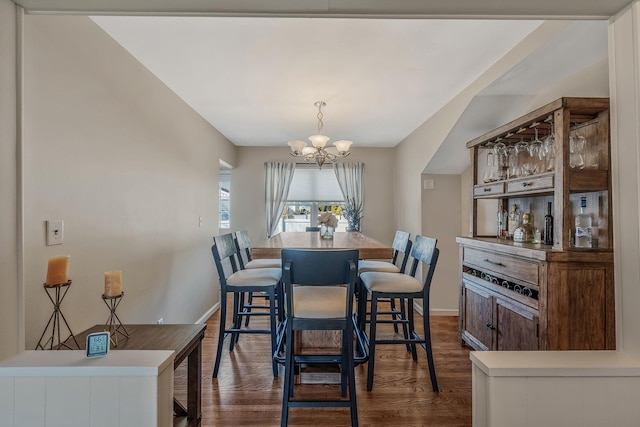 dining area featuring a notable chandelier and dark hardwood / wood-style floors