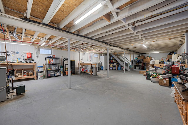 basement featuring fridge and a workshop area