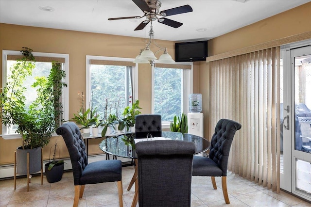 dining room featuring ceiling fan, a healthy amount of sunlight, and light tile patterned floors