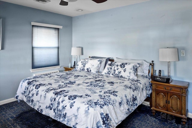 bedroom with dark colored carpet and ceiling fan