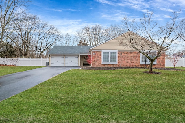 ranch-style house featuring a garage and a front lawn