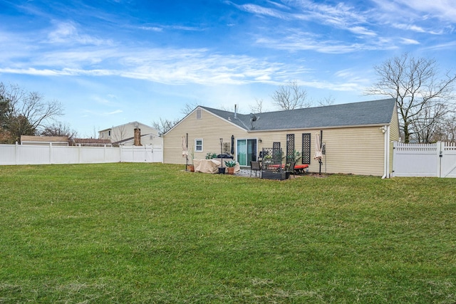 back of property with a patio and a lawn