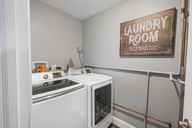 clothes washing area with independent washer and dryer