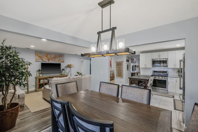 dining space with light hardwood / wood-style floors