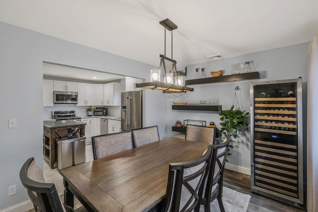 dining room with wine cooler and dark hardwood / wood-style flooring