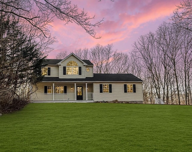 view of front of house featuring a porch and a yard