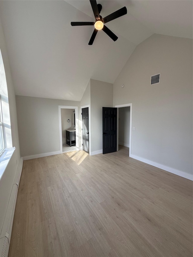 unfurnished living room with light hardwood / wood-style flooring, high vaulted ceiling, ceiling fan, and baseboard heating