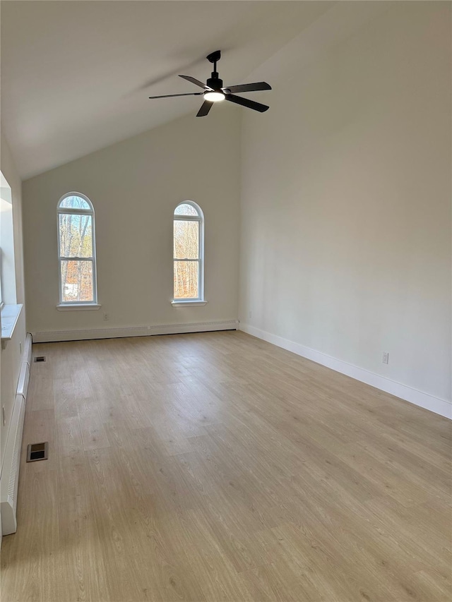 empty room featuring ceiling fan, high vaulted ceiling, and light wood-type flooring