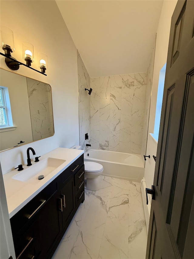 full bathroom with tiled shower / bath, vanity, and toilet