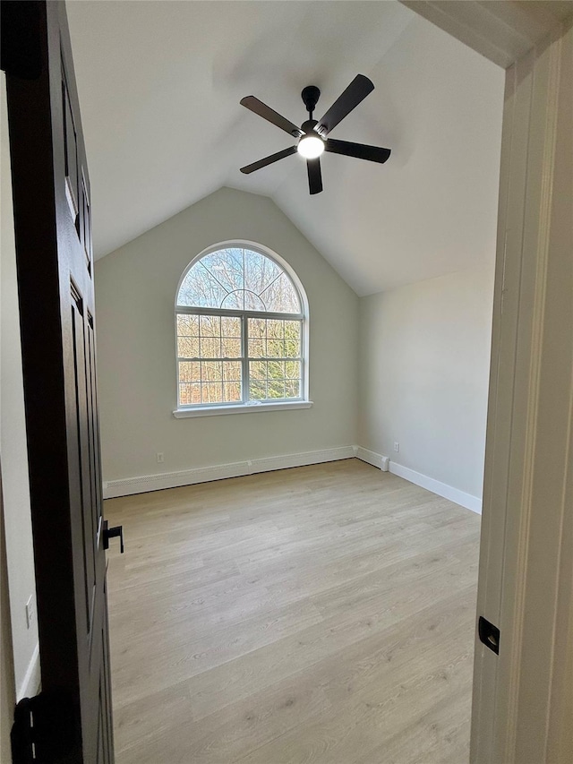 unfurnished room featuring ceiling fan, lofted ceiling, and light hardwood / wood-style floors