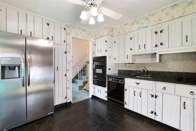 kitchen with sink, dark tile patterned flooring, white cabinets, ceiling fan, and black appliances