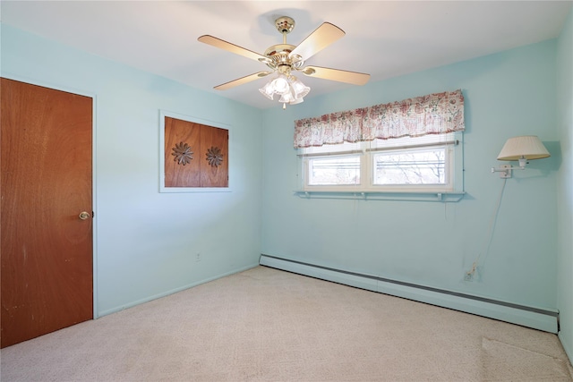 carpeted spare room featuring ceiling fan and baseboard heating