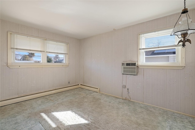 spare room with light colored carpet, an AC wall unit, and baseboard heating