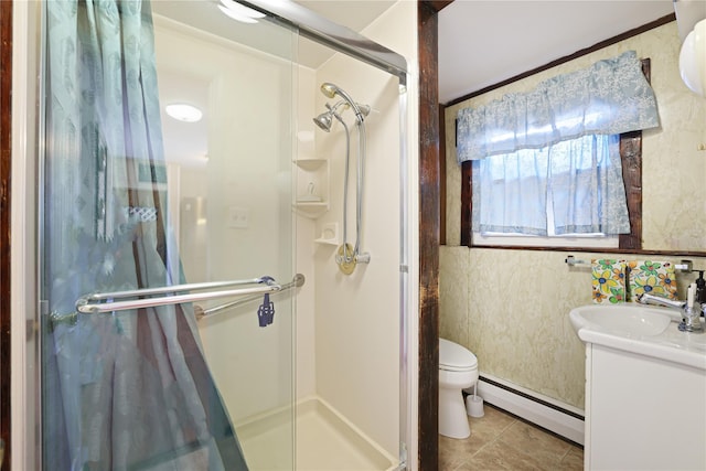 bathroom featuring a shower with door, vanity, a baseboard radiator, tile patterned floors, and toilet