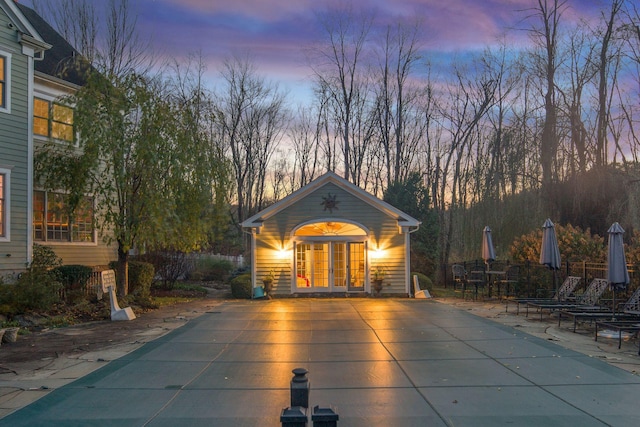 view of pool featuring an outbuilding, a patio, a storage structure, french doors, and a fenced in pool