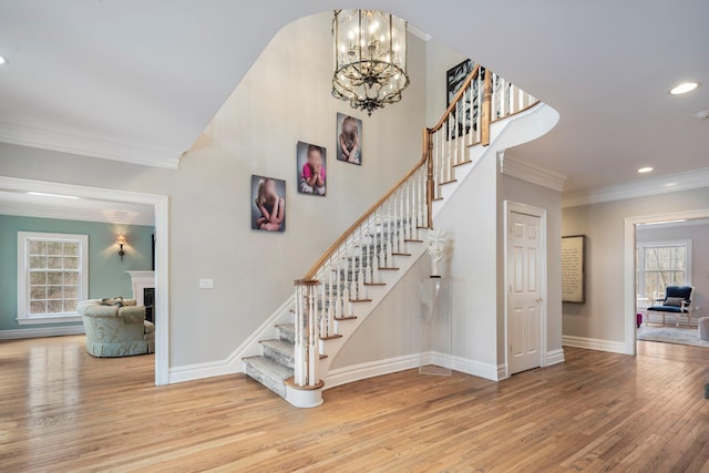 stairs featuring baseboards, recessed lighting, wood finished floors, and crown molding