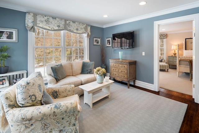 living area with dark wood-type flooring, a wealth of natural light, and crown molding