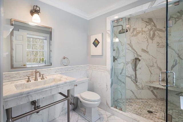 bathroom with toilet, marble finish floor, ornamental molding, wainscoting, and a marble finish shower