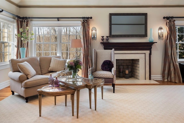 living room featuring light wood-type flooring, a fireplace with flush hearth, and baseboards