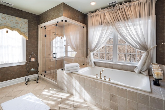 full bath featuring a stall shower, plenty of natural light, and visible vents