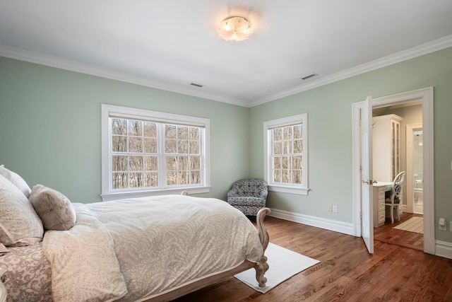 bedroom with baseboards, visible vents, wood finished floors, and ornamental molding