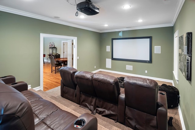 cinema room with recessed lighting, crown molding, light wood-style flooring, and baseboards