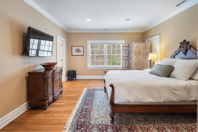 bedroom with visible vents, crown molding, light wood-style flooring, and baseboards