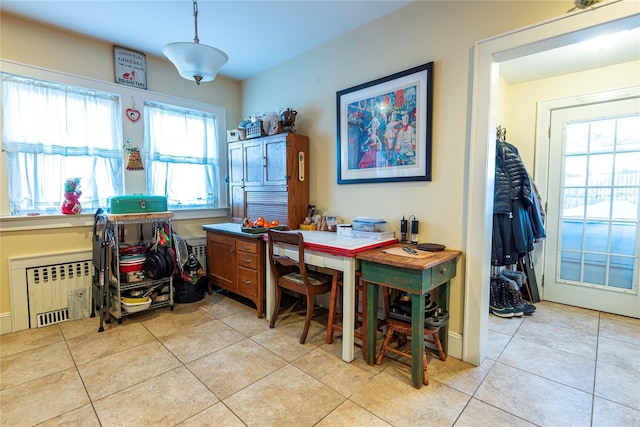 dining area with radiator and light tile patterned floors