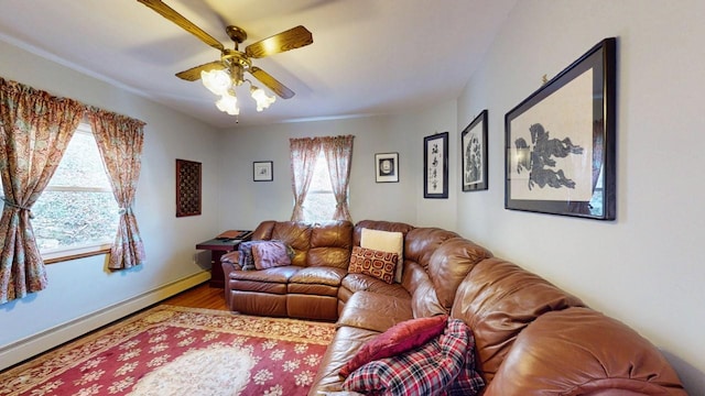 living area featuring baseboards, wood finished floors, ceiling fan, and a baseboard radiator