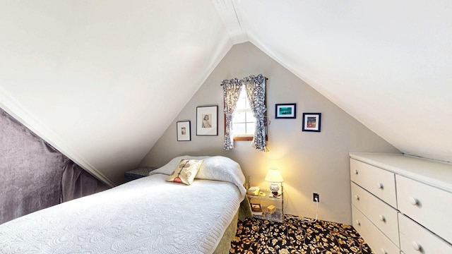 carpeted bedroom with vaulted ceiling