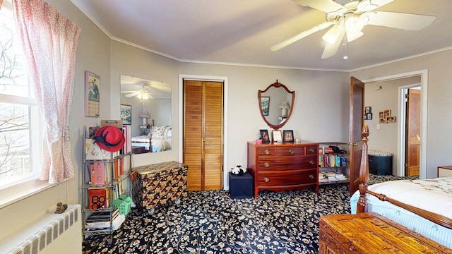 carpeted bedroom featuring a closet, radiator, ceiling fan, and ornamental molding