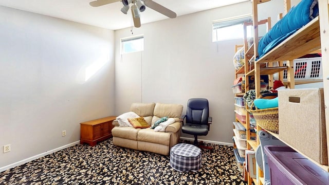 living area featuring baseboards, carpet floors, and ceiling fan