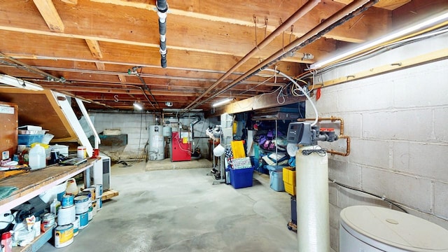 unfinished below grade area featuring water heater and a heating unit