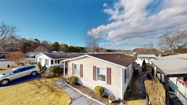 view of side of property with a lawn