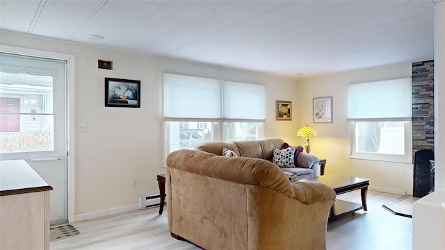 living room with baseboard heating and light hardwood / wood-style flooring