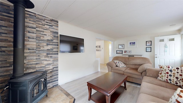 living area featuring a wood stove and wood finished floors