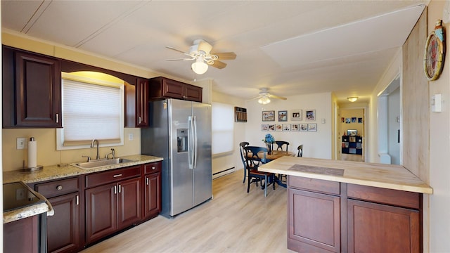 kitchen featuring a sink, stainless steel fridge, light wood-style floors, black / electric stove, and baseboard heating