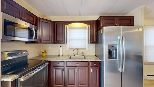 kitchen featuring a sink, light stone counters, stainless steel appliances, a baseboard radiator, and dark brown cabinets