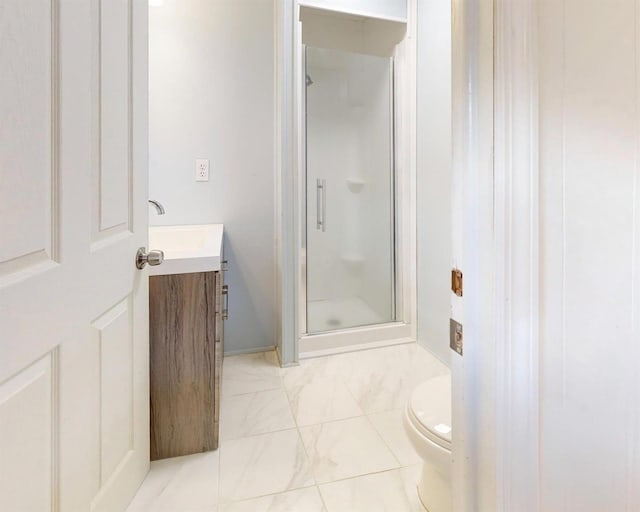 bathroom featuring vanity, marble finish floor, a shower stall, and toilet