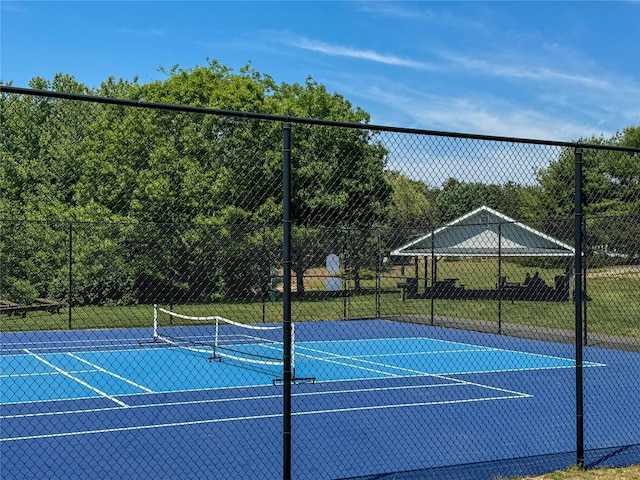 view of tennis court with fence