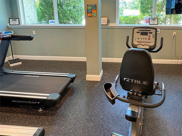 exercise room with plenty of natural light and baseboards