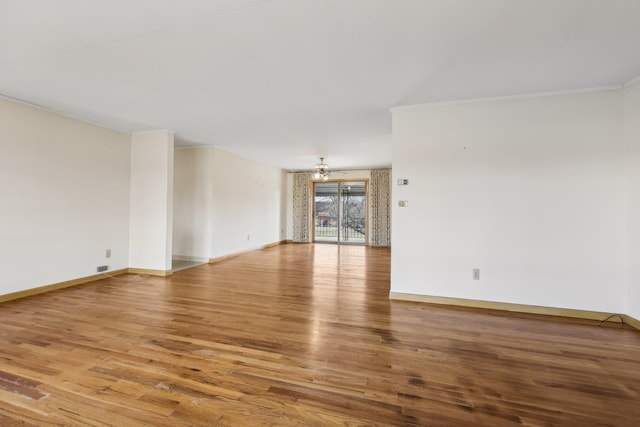 empty room with wood-type flooring and ceiling fan