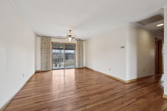 spare room with hardwood / wood-style flooring, ceiling fan, and ornamental molding