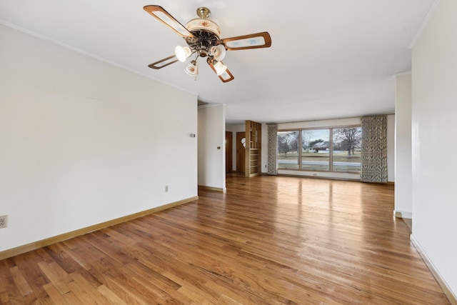 unfurnished living room featuring ornamental molding, ceiling fan, and light wood-type flooring