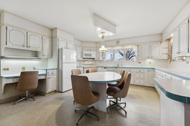 kitchen featuring white cabinetry, white appliances, a kitchen bar, and a center island