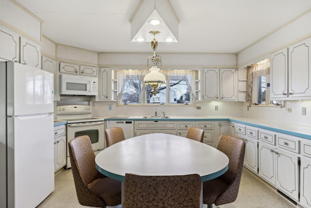 kitchen with white cabinetry, white appliances, sink, and hanging light fixtures