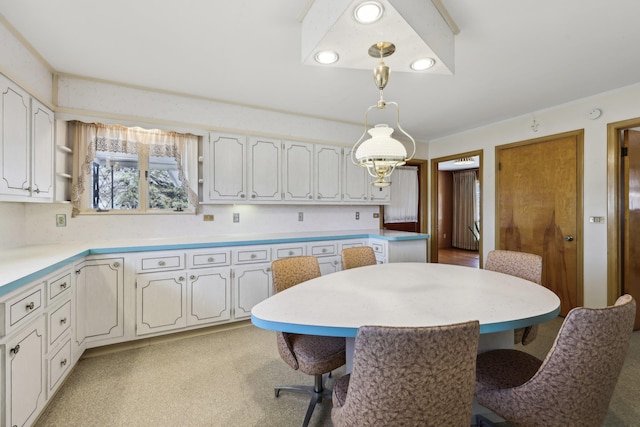 kitchen featuring white cabinetry, a breakfast bar, and hanging light fixtures